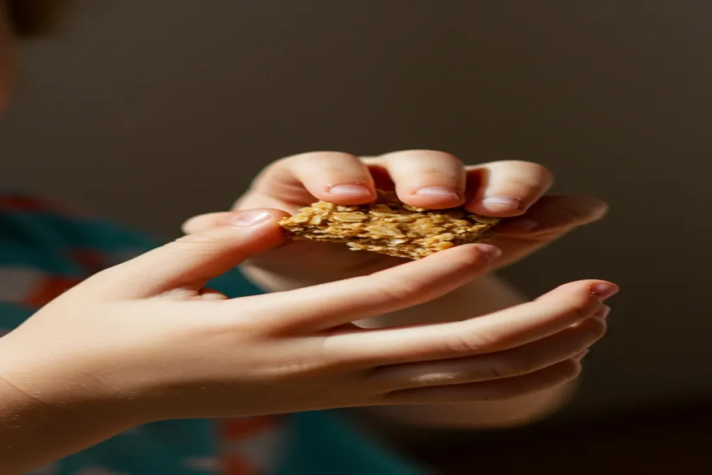 10 Healthy Toddler Oatmeal Recipes (Easy and Nutritious) 4 Toddler holding oatmeal bite recipe square